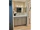 Stylish bathroom with modern vanity, decorative mirror, and ample storage at 4513 Nw 30Th Pl, Ocala, FL 34482