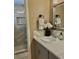 Bathroom featuring a modern vanity, a decorative mirror, and a luxurious tiled shower at 4513 Nw 30Th Pl, Ocala, FL 34482