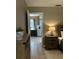 Cozy bedroom featuring a nightstand and doorway leading to a small kitchenette area at 4513 Nw 30Th Pl, Ocala, FL 34482