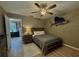 Cozy bedroom with a ceiling fan and marine decor, providing a comfortable and personalized living space at 4513 Nw 30Th Pl, Ocala, FL 34482
