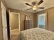 Bedroom with ceiling fan, window with blinds and patterned bedspread at 4513 Nw 30Th Pl, Ocala, FL 34482