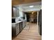Modern kitchen featuring stainless steel appliances, grey cabinets, and an open view to the dining area at 4513 Nw 30Th Pl, Ocala, FL 34482