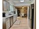 Modern kitchen featuring stainless steel appliances, grey cabinets, and an open view to the dining area at 4513 Nw 30Th Pl, Ocala, FL 34482