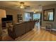 Open-concept living room with wood floors, neutral walls, ceiling fans, and view to dining area at 4513 Nw 30Th Pl, Ocala, FL 34482