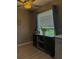 Inviting room with a ceiling fan, exterior door, and large window providing natural light and a comfortable atmosphere at 4513 Nw 30Th Pl, Ocala, FL 34482