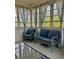 Enclosed sunroom featuring cozy seating, neutral color palette, and lots of natural light at 4513 Nw 30Th Pl, Ocala, FL 34482