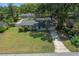 Charming home with well-manicured lawn, long driveway, and mature trees offering curb appeal and shade at 511 Se 29Th Ter, Ocala, FL 34471
