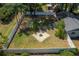 Aerial view of large fenced backyard featuring a fire pit, mature trees, and providing a private outdoor space at 511 Se 29Th Ter, Ocala, FL 34471