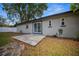Backyard featuring a concrete patio, stepping stone pathway, and well-maintained landscaping at 511 Se 29Th Ter, Ocala, FL 34471