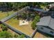 Aerial view of large fenced backyard featuring a fire pit, mature trees, and providing a private outdoor space at 511 Se 29Th Ter, Ocala, FL 34471