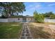 Backyard features stone pathway and a sliding door, blending indoor and outdoor living seamlessly at 511 Se 29Th Ter, Ocala, FL 34471