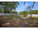 Spacious backyard features large trees, concrete patio, and a pristine white fence, enhancing privacy at 511 Se 29Th Ter, Ocala, FL 34471