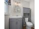 Updated bathroom with gray vanity, decorative lighting, and a tiled shower/tub combo at 511 Se 29Th Ter, Ocala, FL 34471