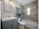 Renovated bathroom with gray vanity, updated fixtures, and a tiled shower and tub at 511 Se 29Th Ter, Ocala, FL 34471