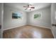 Bedroom with wood-look flooring and two windows at 511 Se 29Th Ter, Ocala, FL 34471