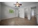 Bedroom with wood-look flooring, closet, and view of greenery through the window at 511 Se 29Th Ter, Ocala, FL 34471