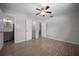 Bedroom with wood-look tile flooring, ceiling fan, and doorways to the bathroom and hallway at 511 Se 29Th Ter, Ocala, FL 34471