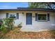 Close up of the front entrance showing the blue door, blue shutters, and house number at 511 Se 29Th Ter, Ocala, FL 34471