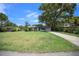 Inviting single-story home with lush green lawn, mature trees and long driveway at 511 Se 29Th Ter, Ocala, FL 34471