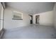 Spacious garage with painted block walls, window, blue door, and utility room access for added convenience at 511 Se 29Th Ter, Ocala, FL 34471