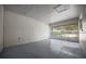 View of the garage with white plank wall and sliding glass doors to the backyard, enhancing the space at 511 Se 29Th Ter, Ocala, FL 34471