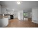 Bright kitchen with white cabinets, black appliances, wood-look tile flooring and natural light at 511 Se 29Th Ter, Ocala, FL 34471
