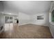 Bright living room with wood-look tile flooring, neutral walls and sliding doors at 511 Se 29Th Ter, Ocala, FL 34471