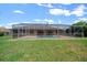 Expansive backyard with pool enclosure, offering a private and serene outdoor space for relaxation and recreation at 5420 Sw 86Th Ln, Ocala, FL 34476