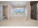 Bathroom featuring a soaking tub under a window and a glass door shower at 5420 Sw 86Th Ln, Ocala, FL 34476