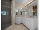 Bathroom featuring a glass shower and expansive vanity with dual sinks and ample storage at 5420 Sw 86Th Ln, Ocala, FL 34476