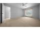 Inviting bedroom with carpeting, a ceiling fan, and a window offering pleasant views at 5420 Sw 86Th Ln, Ocala, FL 34476