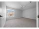Bright bedroom with a ceiling fan, plush carpeting, and a large window letting in natural light at 5420 Sw 86Th Ln, Ocala, FL 34476