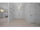Bright foyer featuring double doors, tile flooring, and decorative light fixtures that add a touch of elegance at 5420 Sw 86Th Ln, Ocala, FL 34476