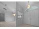 Light-filled foyer with double doors, tile flooring, and stylish light fixtures that create an inviting entrance at 5420 Sw 86Th Ln, Ocala, FL 34476