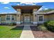 Inviting front entrance with large pillars, a decorative door, and beautifully landscaped surroundings at 5420 Sw 86Th Ln, Ocala, FL 34476