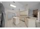 Kitchen with a central island, white cabinetry, and tiled flooring at 5420 Sw 86Th Ln, Ocala, FL 34476