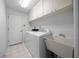 Functional laundry room with washer, dryer, sink, and storage cabinets at 5420 Sw 86Th Ln, Ocala, FL 34476