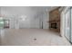 Open living room with tiled flooring, brick fireplace, and a seamless connection to the rest of the house at 5420 Sw 86Th Ln, Ocala, FL 34476