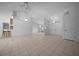 Open-concept living area with tile floors, vaulted ceilings, skylights, and seamless flow into other living spaces at 5420 Sw 86Th Ln, Ocala, FL 34476