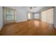 Spacious living room with hardwood floors and large windows allowing natural light at 5420 Sw 86Th Ln, Ocala, FL 34476