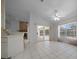 Bright living space adjacent to the kitchen features tile floors, a view of the pool, and sliding glass doors at 5420 Sw 86Th Ln, Ocala, FL 34476