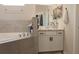 Well-lit bathroom featuring a tub and vanity with granite counters and white cabinets at 5515 Se 91St St, Ocala, FL 34480