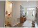 Inviting entryway with a wooden console table, decorative accents, and a view of the half bathroom at 5515 Se 91St St, Ocala, FL 34480