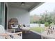 Cozy covered patio area featuring stylish furniture, perfect for enjoying the outdoors in comfort at 5515 Se 91St St, Ocala, FL 34480