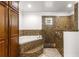 Bathroom featuring a tub and glass-enclosed shower at 6045 Se 99Th Pl, Belleview, FL 34420