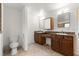 Bathroom with dual vanities and a separate toilet area at 6045 Se 99Th Pl, Belleview, FL 34420