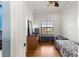 Bedroom features a window with blinds and a view of the outdoors at 6045 Se 99Th Pl, Belleview, FL 34420