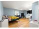 Bedroom featuring hardwood floors and a large window at 6045 Se 99Th Pl, Belleview, FL 34420
