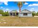 Charming single-story home with a metal roof, screened porch and a well manicured lawn at 6045 Se 99Th Pl, Belleview, FL 34420