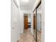 Hallway view of mirrored closet doors and bathroom entrance at 6045 Se 99Th Pl, Belleview, FL 34420